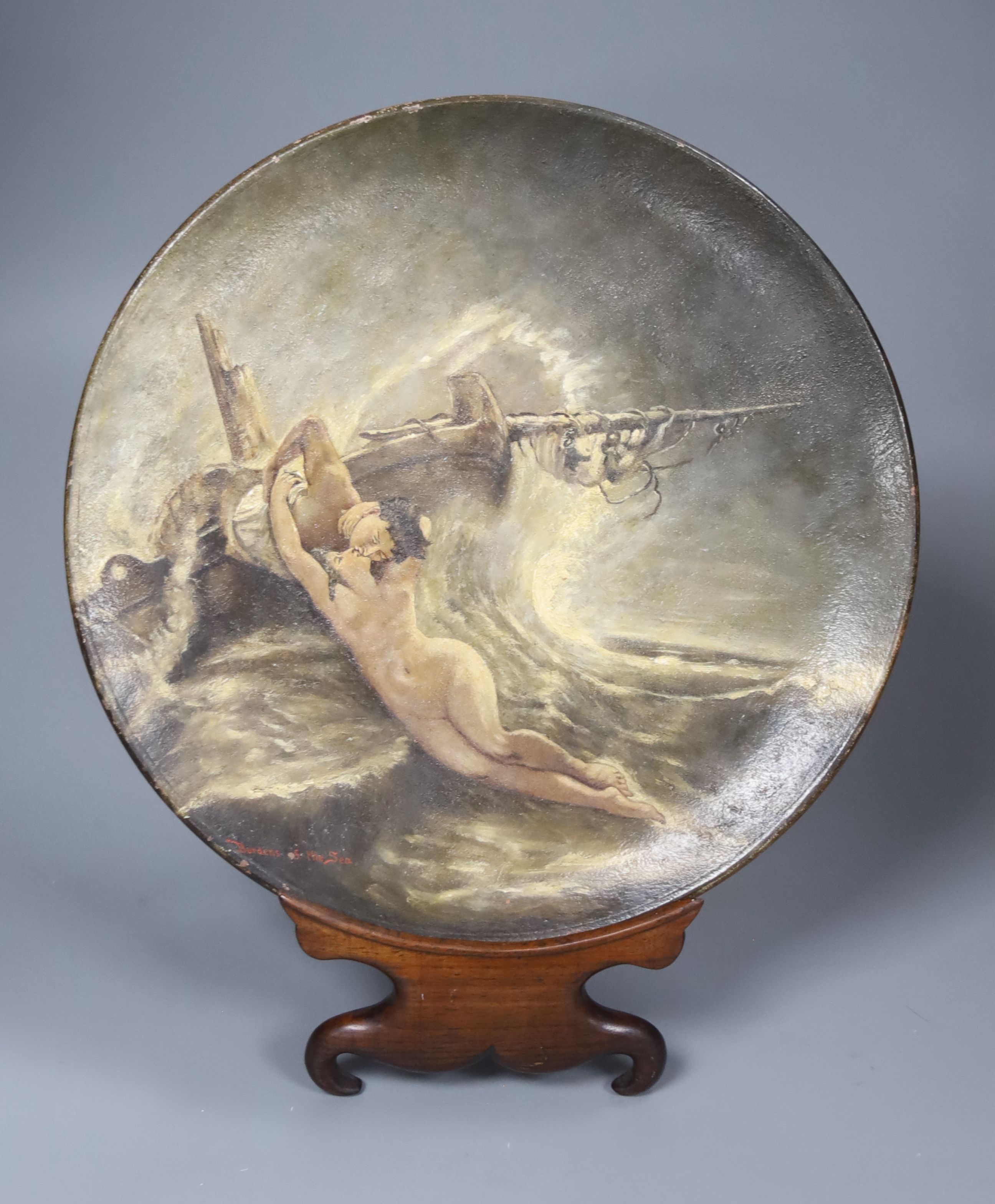 A Watcombe Torquay outside decorated terracotta plate Burdens of the Sea, on stand, diameter 27cm